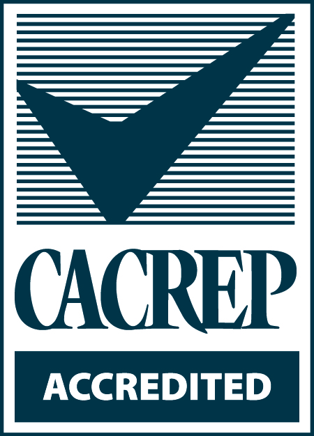 Logo of the Council for Accreditation of Counseling and Related Educational Programs (CACREP). The logo has a blue checkmark on a blue-and-white striped background. Beneath it are the words "CACREP ACCREDITED."